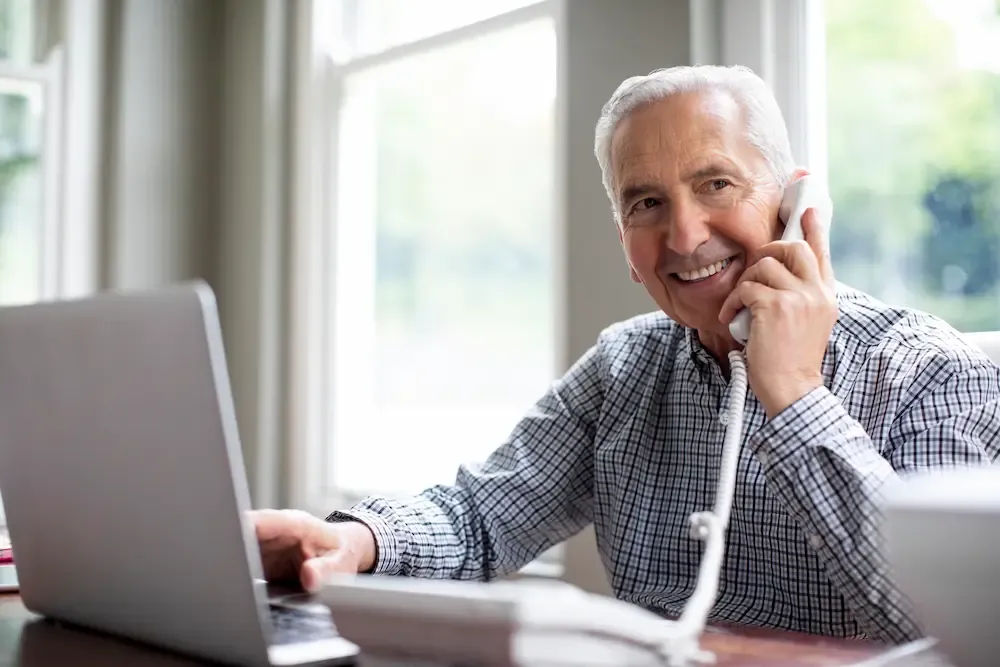 mature man talking on landline phone